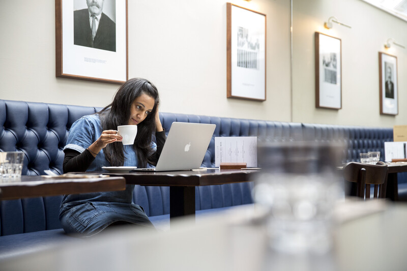 Woman sitting looking at a laptop